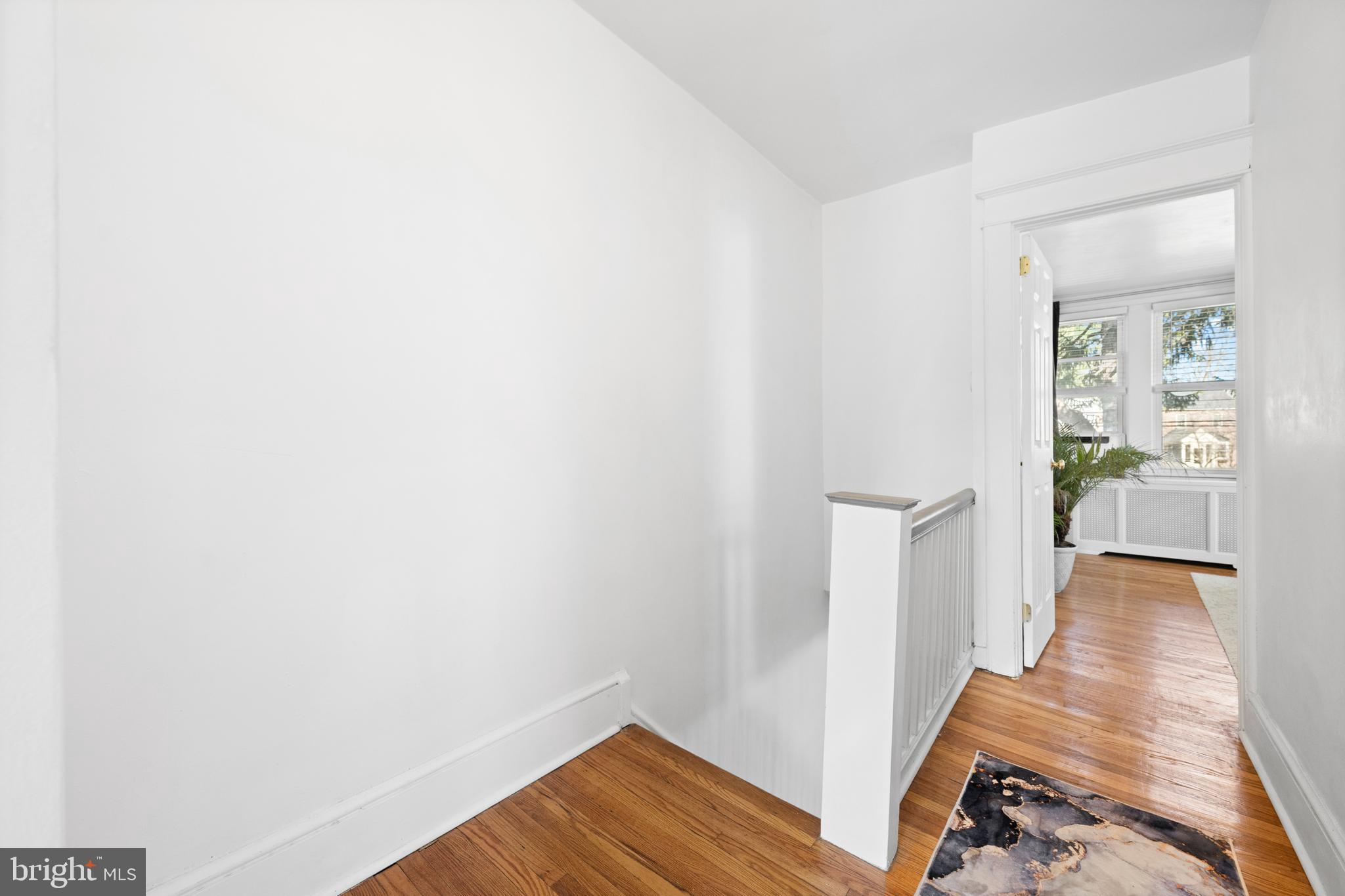 116 Marshall Road Lansdowne, PA 19050 - Photo 34 of 40 a view of a hallway with wooden floor and a bathroom