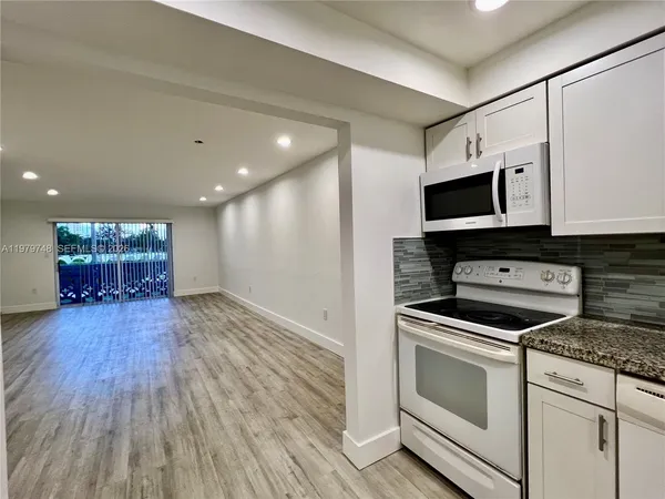 a kitchen with a stove and a microwave
