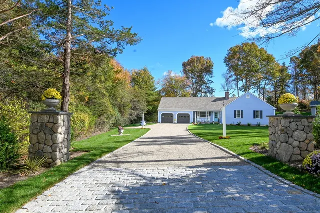 a front view of a house with a yard and outdoor seating