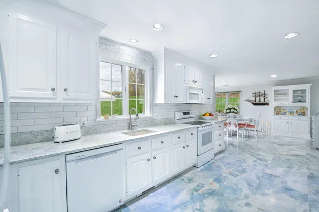 a living room with a fireplace and wooden floor