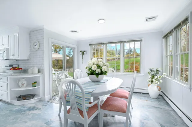 a view of a dining room with furniture wooden floor and a chandelier