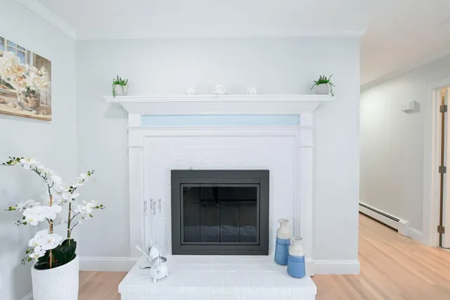 a bedroom with a bed and a potted plant