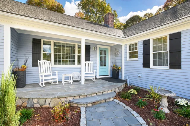 a spacious bedroom with a bed and a mirror