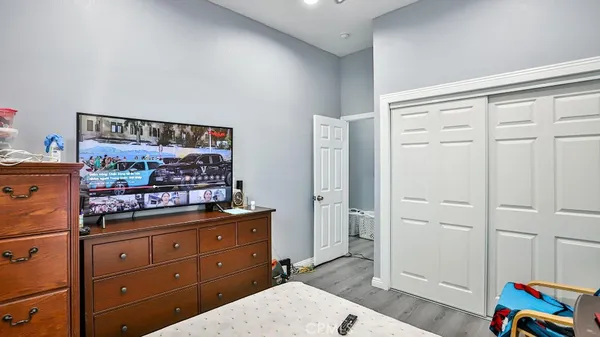 a room with a baby crib and dresser
