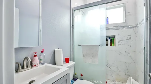 a bathroom with a sink toilet and shower