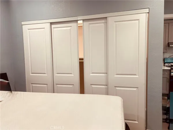 a bedroom with a bed and a cabinet