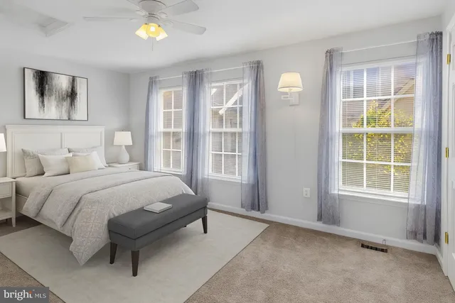 a spacious bedroom with a bed and a window