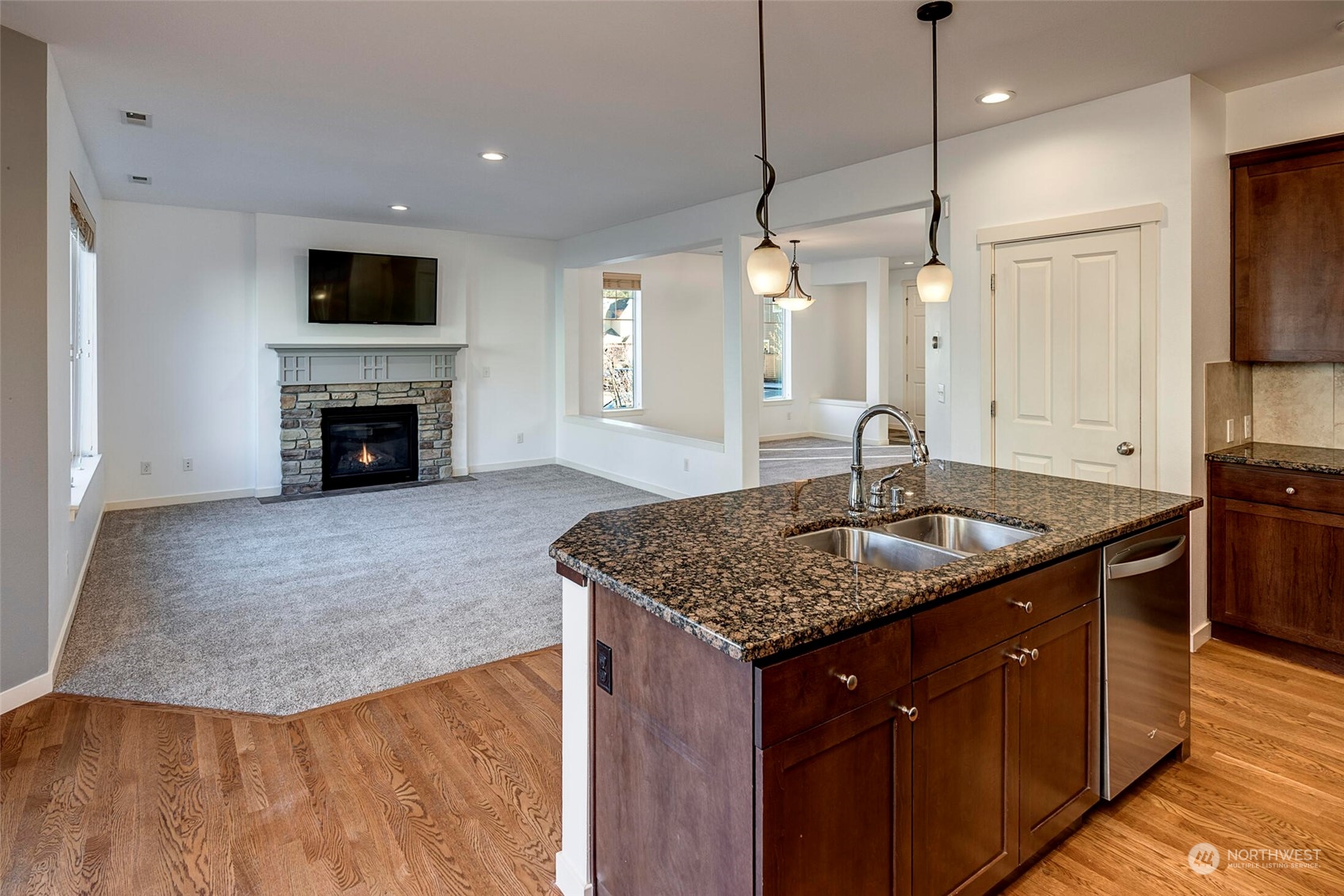 4812 Northeast 2nd Place Renton, WA 98059 - Photo 11 of 26 a kitchen with stainless steel appliances granite countertop a sink a oven and a wooden floors