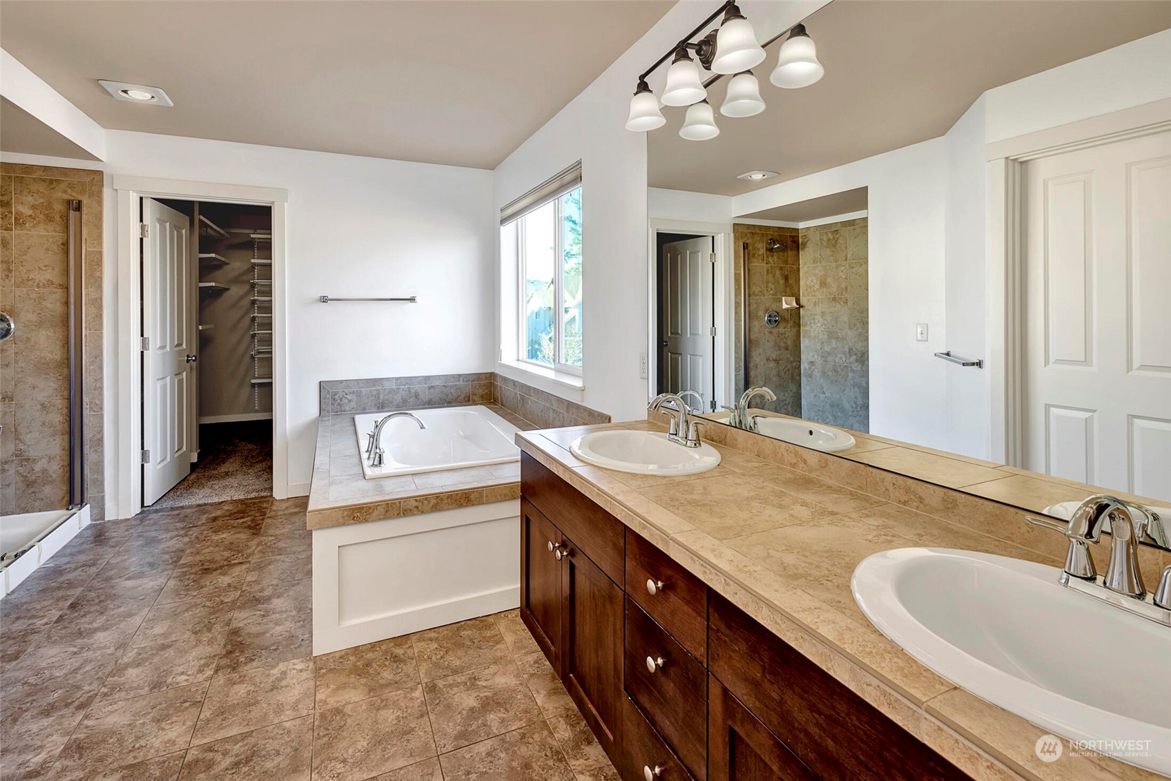 4812 Northeast 2nd Place Renton, WA 98059 - Photo 17 of 26 a spacious bathroom with a granite countertop sink a mirror and a shower