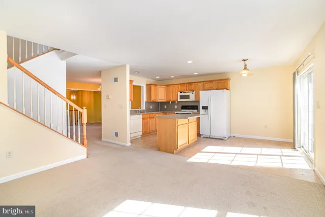 a view of a kitchen with a sink and a refrigerator