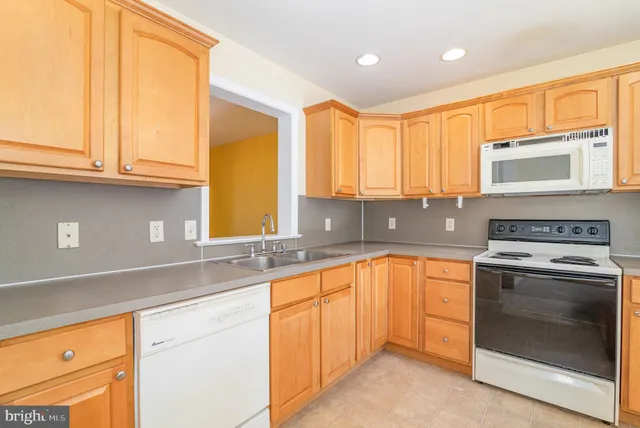 a kitchen with stainless steel appliances granite countertop a sink and cabinets