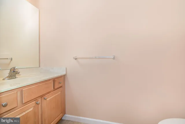 a bathroom with a granite countertop sink and vanity