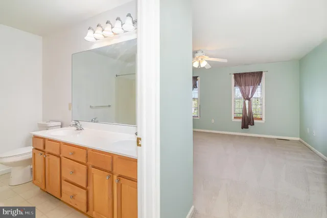 a bathroom with a sink vanity and mirror