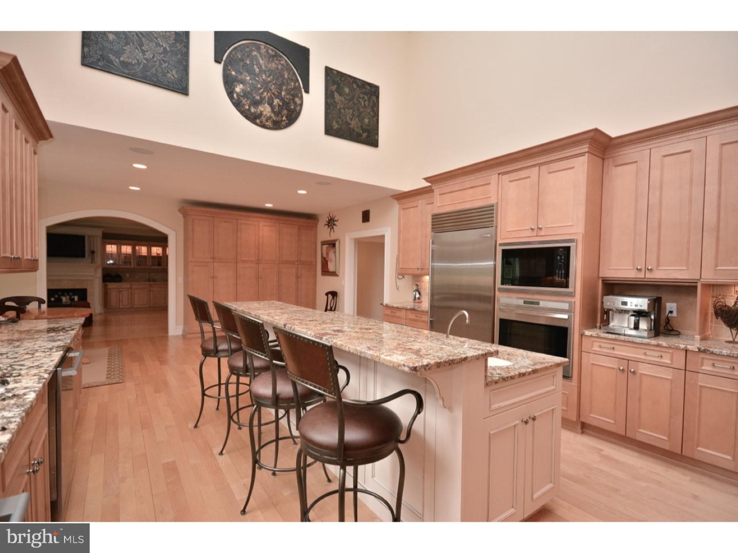 4571 Province Line Road Princeton, NJ 08540 - Photo 8 of 25 a kitchen with stainless steel appliances kitchen island granite countertop a stove a sink a dining table and chairs