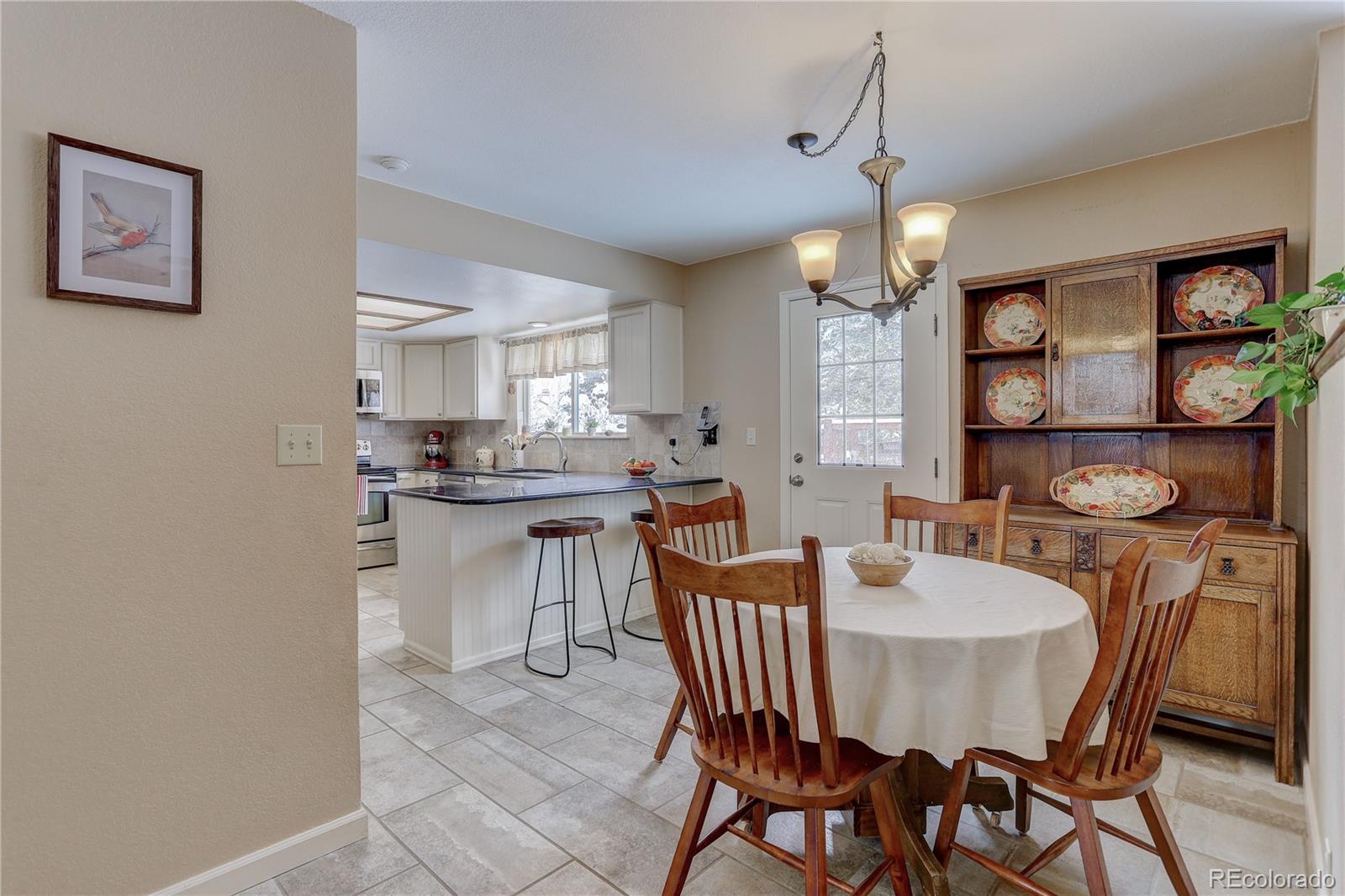 431 Mountain Chickadee Road Highlands Ranch, CO 80126 - Photo 11 of 38 a view of a dining room with furniture