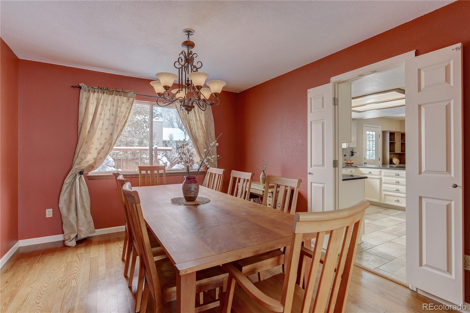 431 Mountain Chickadee Road Highlands Ranch, CO 80126 - Photo 12 of 38 a view of a dining room with furniture window and wooden floor