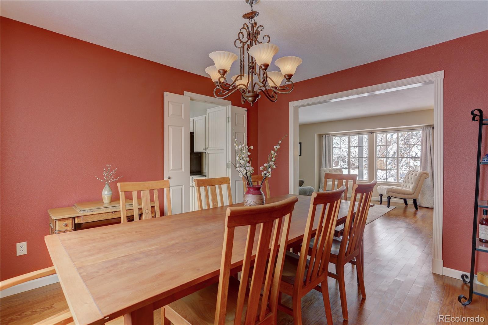 431 Mountain Chickadee Road Highlands Ranch, CO 80126 - Photo 13 of 38 a view of a dining room with furniture and a chandelier