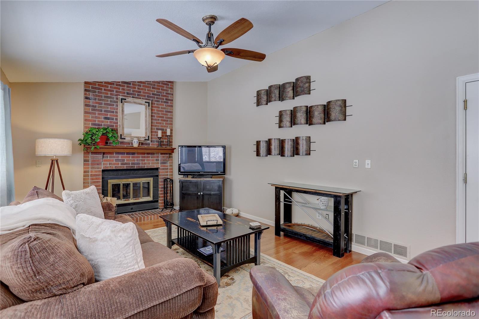 431 Mountain Chickadee Road Highlands Ranch, CO 80126 - Photo 15 of 38 a living room with furniture a fireplace and a large window