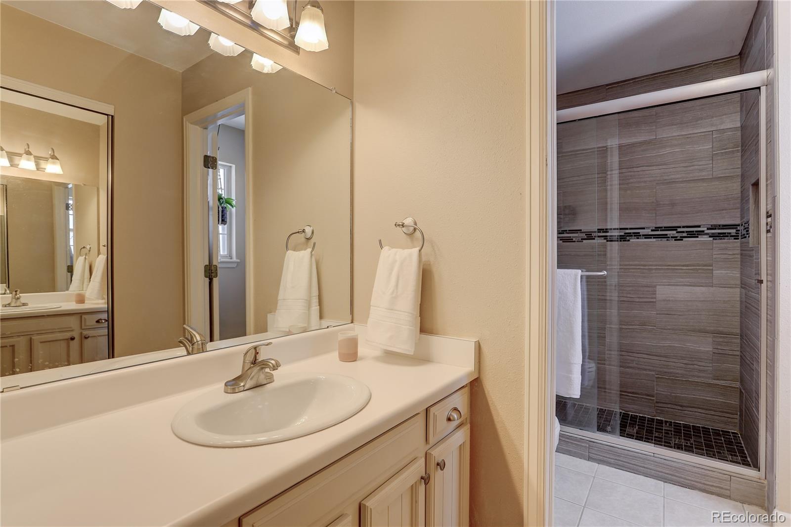 431 Mountain Chickadee Road Highlands Ranch, CO 80126 - Photo 19 of 38 a bathroom with a sink and a mirror
