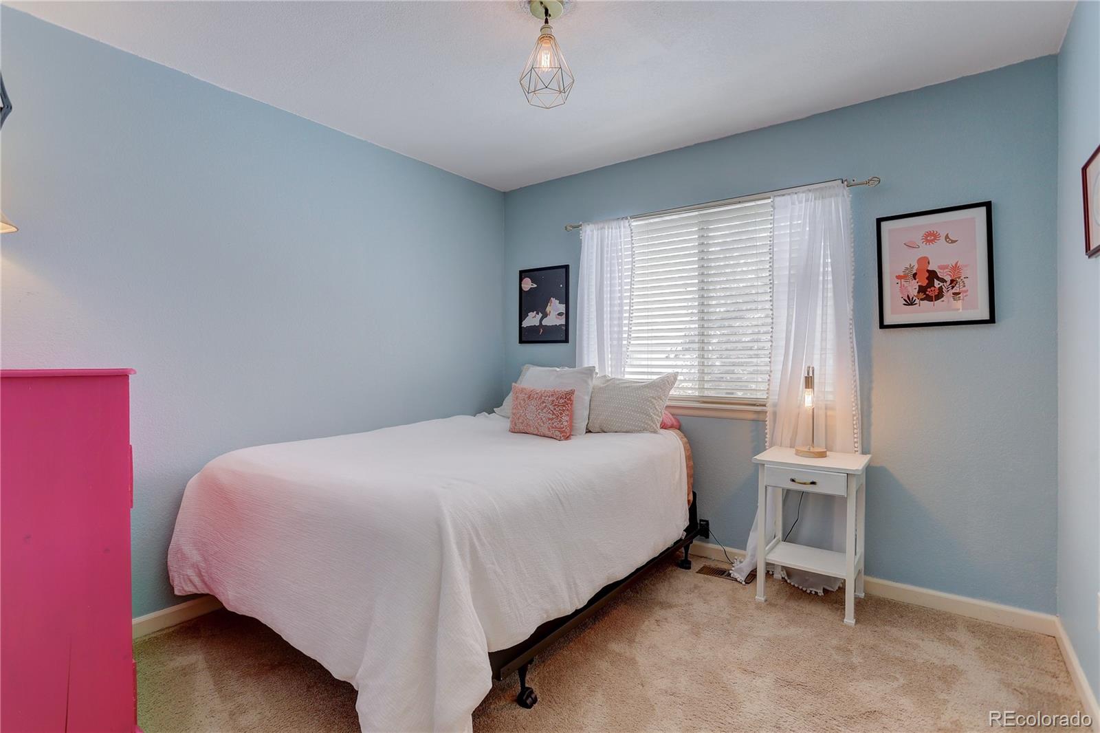 431 Mountain Chickadee Road Highlands Ranch, CO 80126 - Photo 23 of 38 a bedroom with a bed and a window
