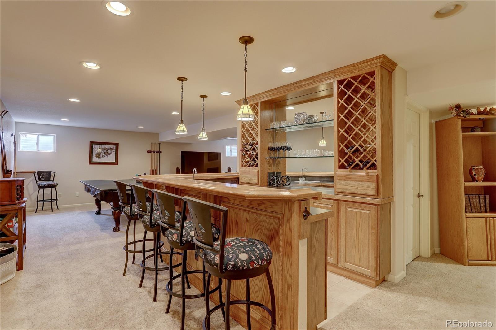 431 Mountain Chickadee Road Highlands Ranch, CO 80126 - Photo 26 of 38 a kitchen with stainless steel appliances kitchen island granite countertop a table and chairs in it