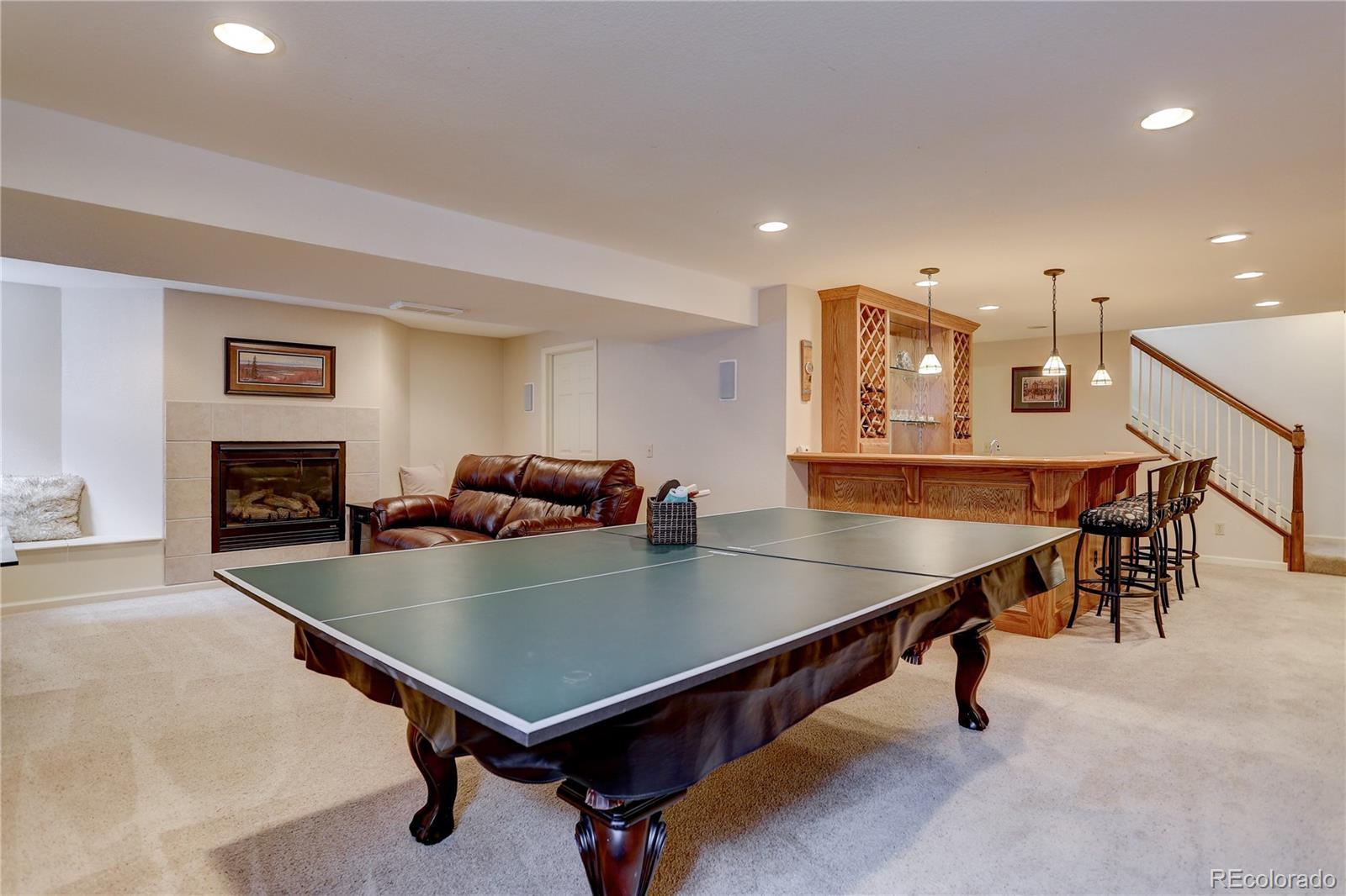 431 Mountain Chickadee Road Highlands Ranch, CO 80126 - Photo 29 of 38 a room with furniture pool table table tennis and stairs