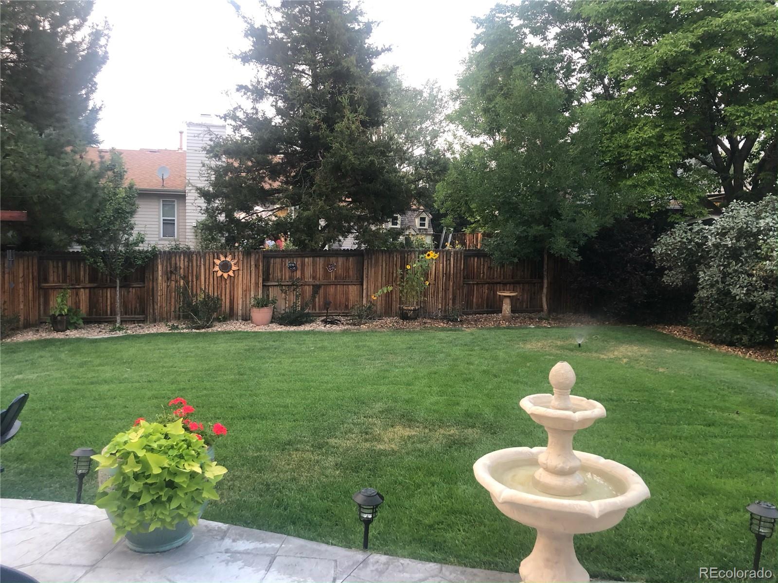 431 Mountain Chickadee Road Highlands Ranch, CO 80126 - Photo 35 of 38 a view of a garden with a fountain