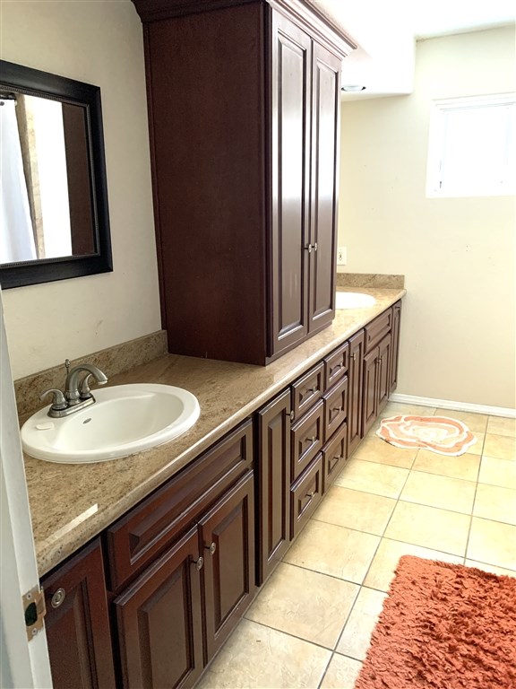 62 Pepper Tree Road Chula Vista, CA 91910 - Photo 11 of 17 a bathroom with a granite countertop sink and a mirror