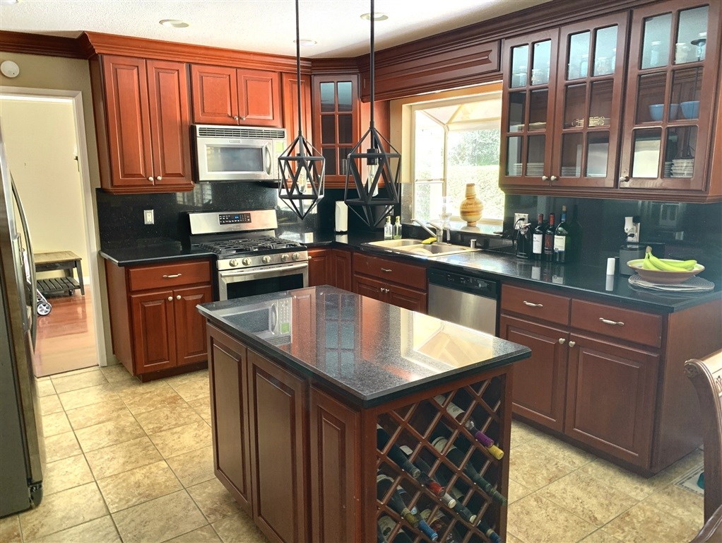 62 Pepper Tree Road Chula Vista, CA 91910 - Photo 8 of 17 a kitchen with stainless steel appliances granite countertop a sink stove and refrigerator