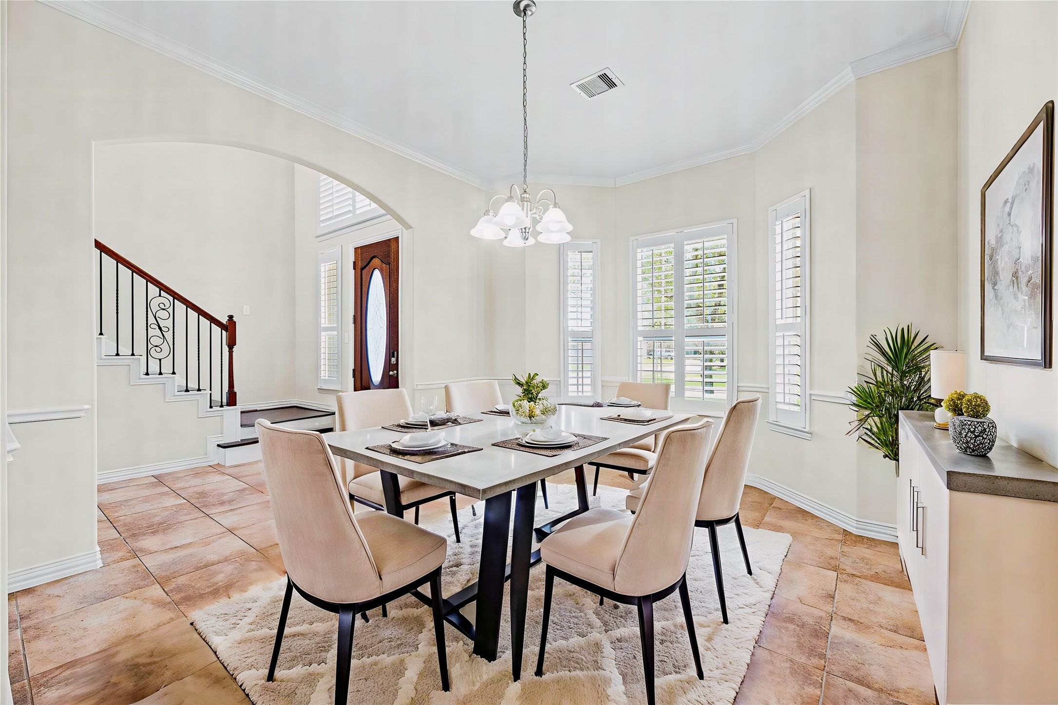 3315 Tulip Ranch Drive Katy, TX 77494 - Photo 7 of 23 The dining room, located just off the entry, has large bay windows with shutters that fill the space with natural light, a stylish chandelier, and ample room for dining. The dining room is virtually staged so you can imagine the possibilities.