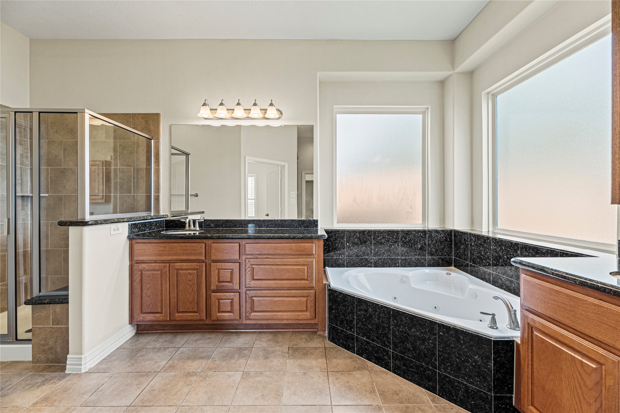 3315 Tulip Ranch Drive Katy, TX 77494 - Photo 9 of 23 Your private bath features an oversized walk-in shower with beautiful tile work, a relaxing jetted tub, and separate vanities for added convenience.