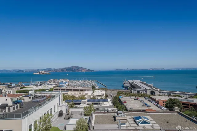 an aerial view of residential houses with city view