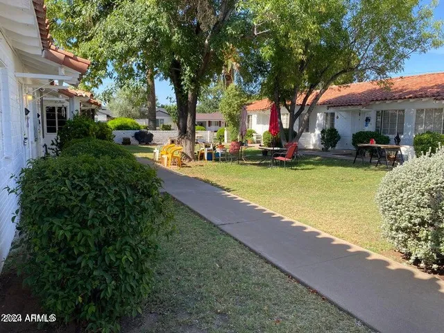 a view of a house with swimming pool and sitting area
