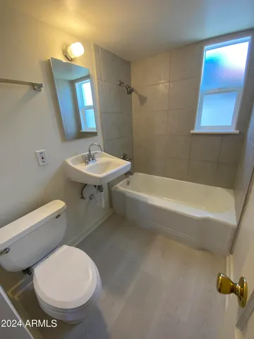 a bathroom with a toilet a sink and bathtub