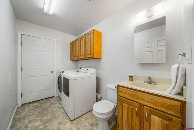 a bathroom with a sink toilet and mirror
