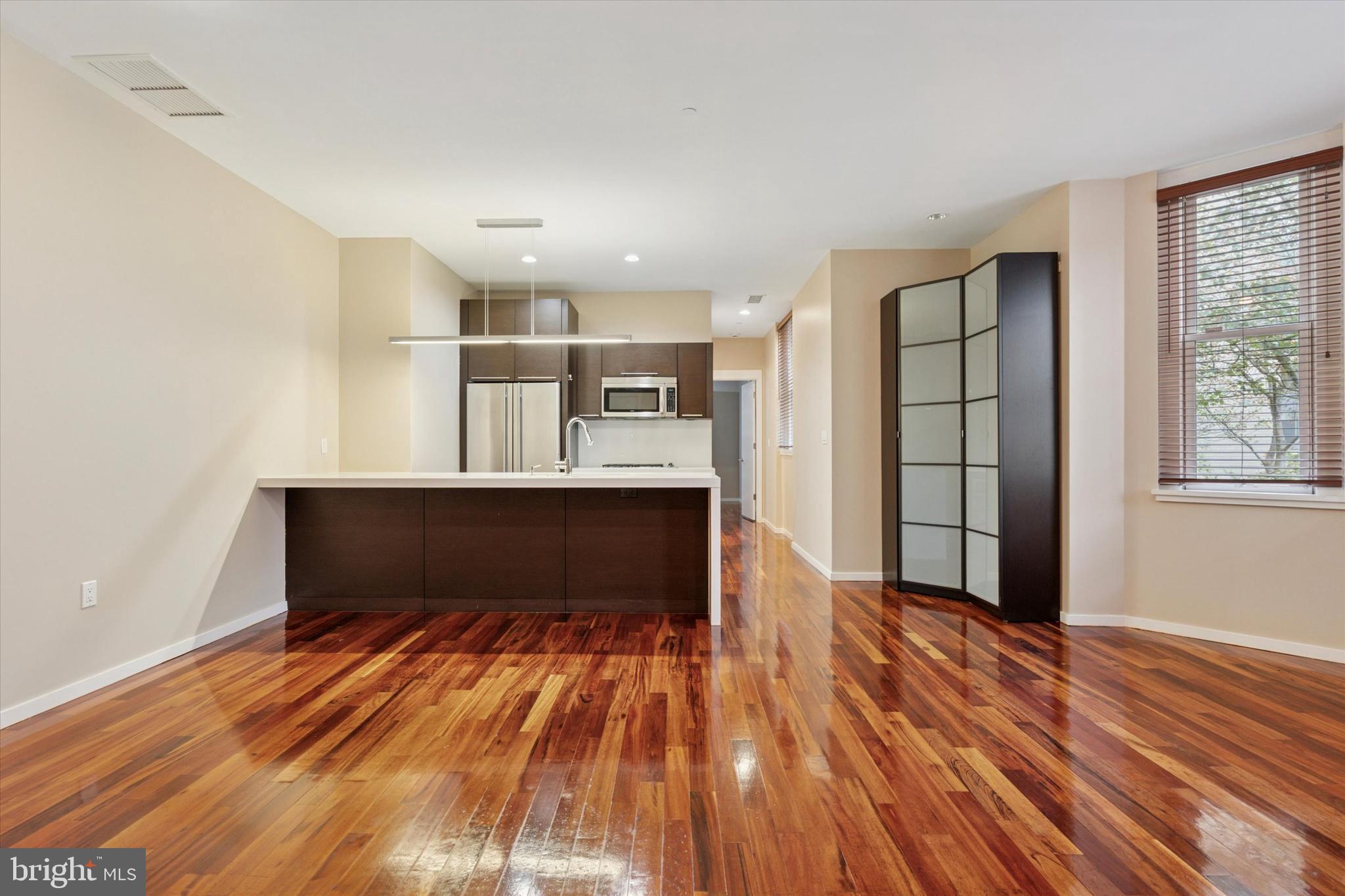 4200 Pine Street, Unit 103 Philadelphia, PA 19104 - Photo 11 of 35 an empty room with wooden floor and windows