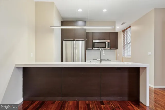 a kitchen with stainless steel appliances granite countertop a sink and a microwave