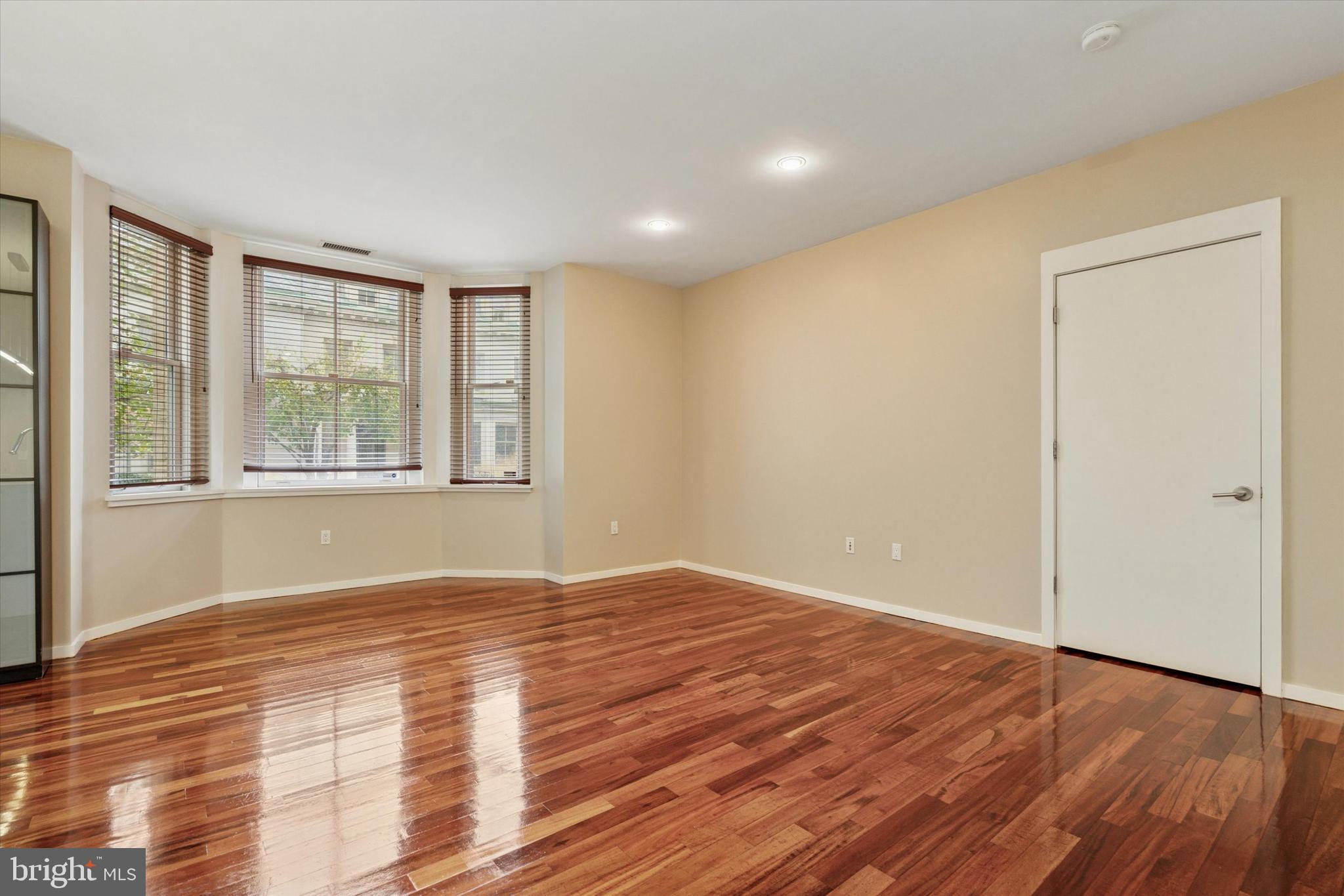 4200 Pine Street, Unit 103 Philadelphia, PA 19104 - Photo 19 of 35 a view of an empty room with wooden floor and a window
