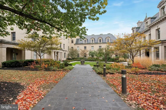 a view of a street with a houses in the background