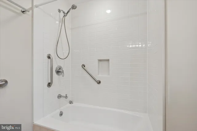 a bathroom with a sink a mirror and a shower