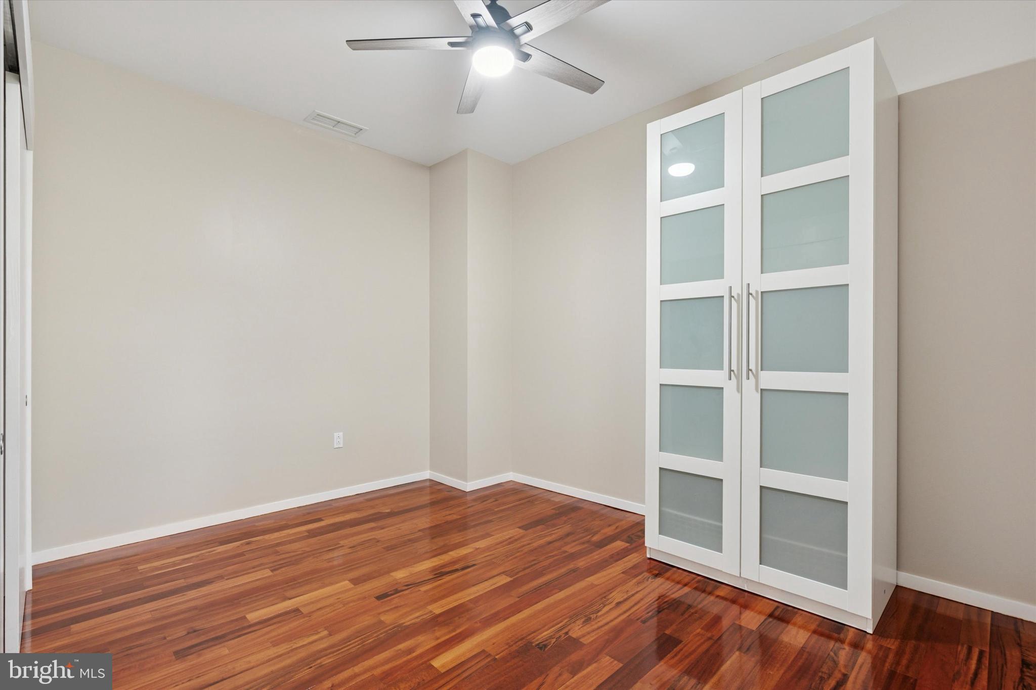 4200 Pine Street, Unit 103 Philadelphia, PA 19104 - Photo 30 of 35 a view of an empty room with a window and wooden floor