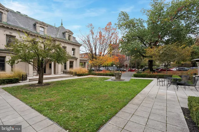 a view of yard with swimming pool and sitting area