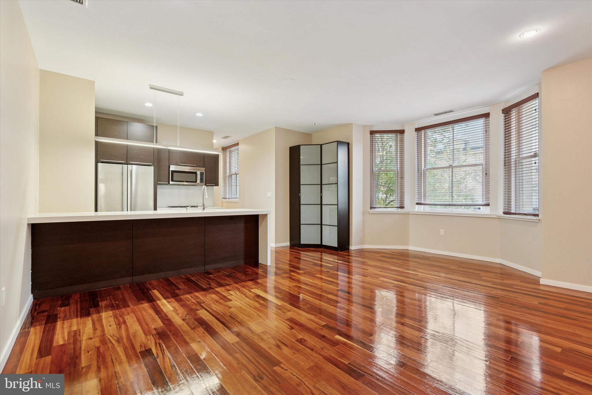 4200 Pine Street, Unit 103 Philadelphia, PA 19104 - Photo 10 of 35 a view of an empty room with window and wooden floor