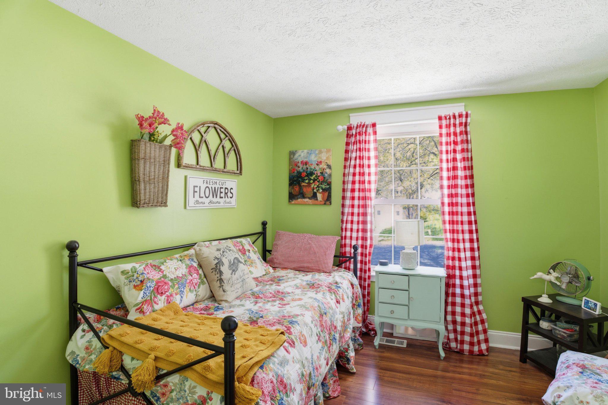 291 Waycross Way Arnold, MD 21012 - Photo 17 of 34 Charming green bedroom with floral accents.