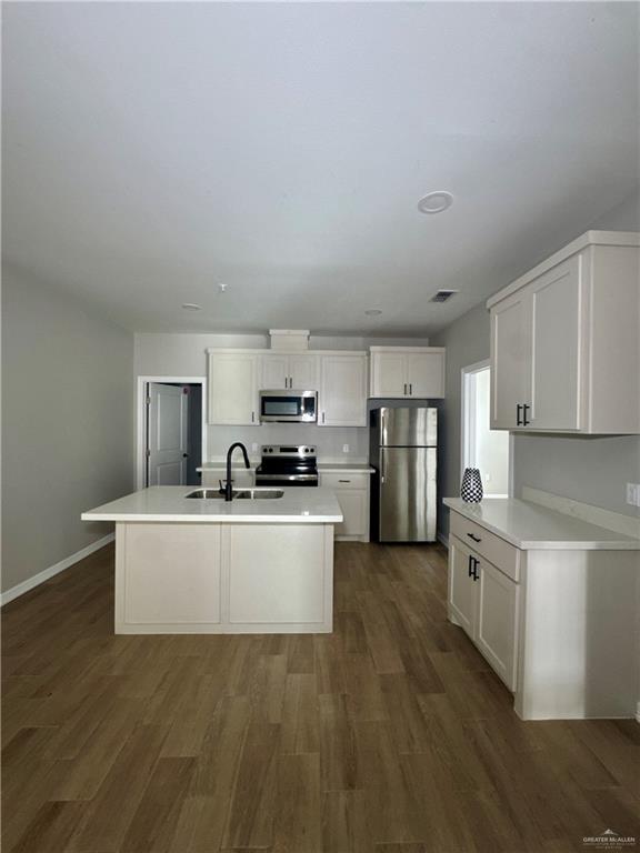 720 Ragland Road, Unit 8 Mission, TX 78572 - Photo 15 of 17 a kitchen with stainless steel appliances a refrigerator and a stove top oven