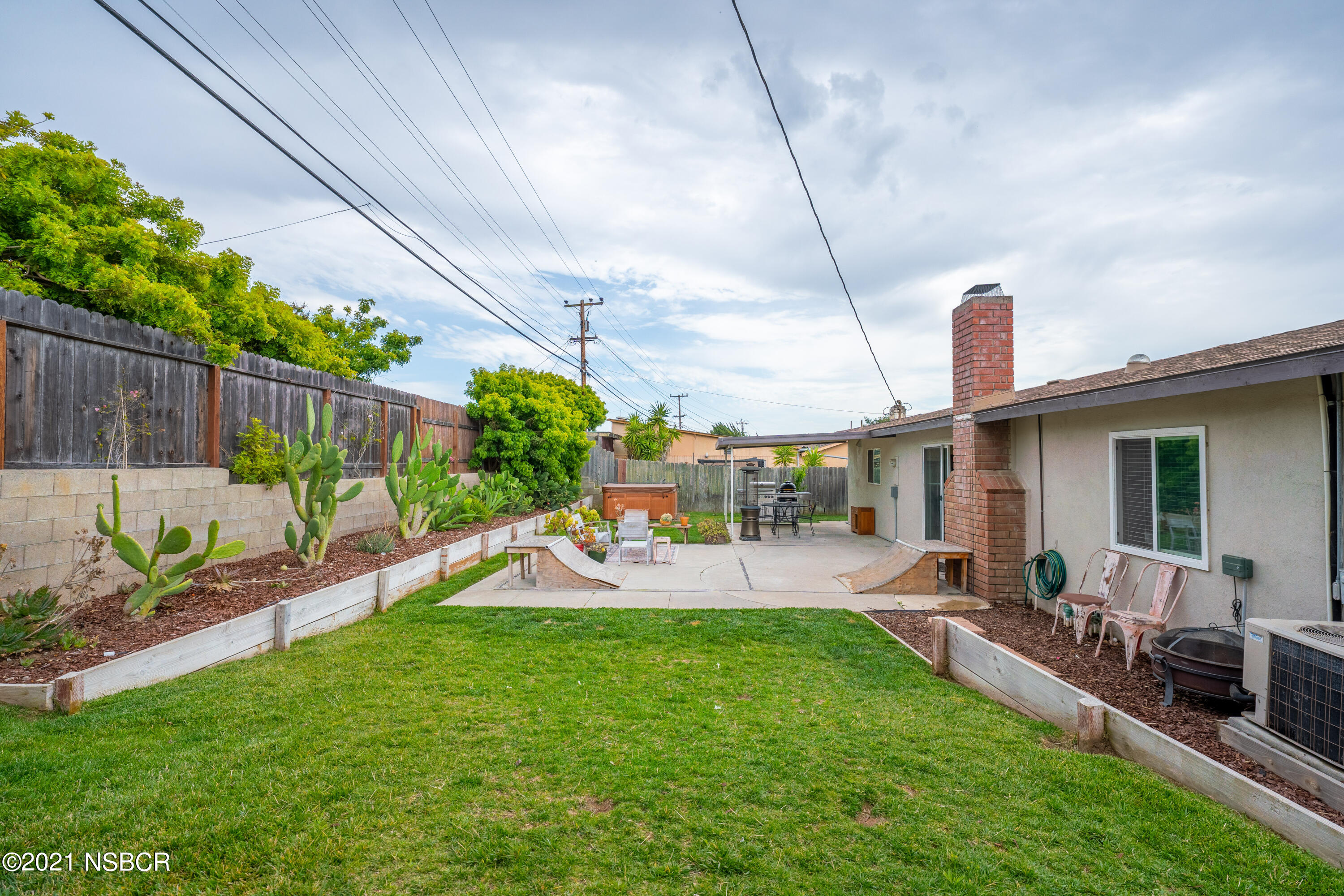 3985 Constellation Road Lompoc, CA 93436 - Photo 23 of 25 a view of a backyard with couches under an umbrella