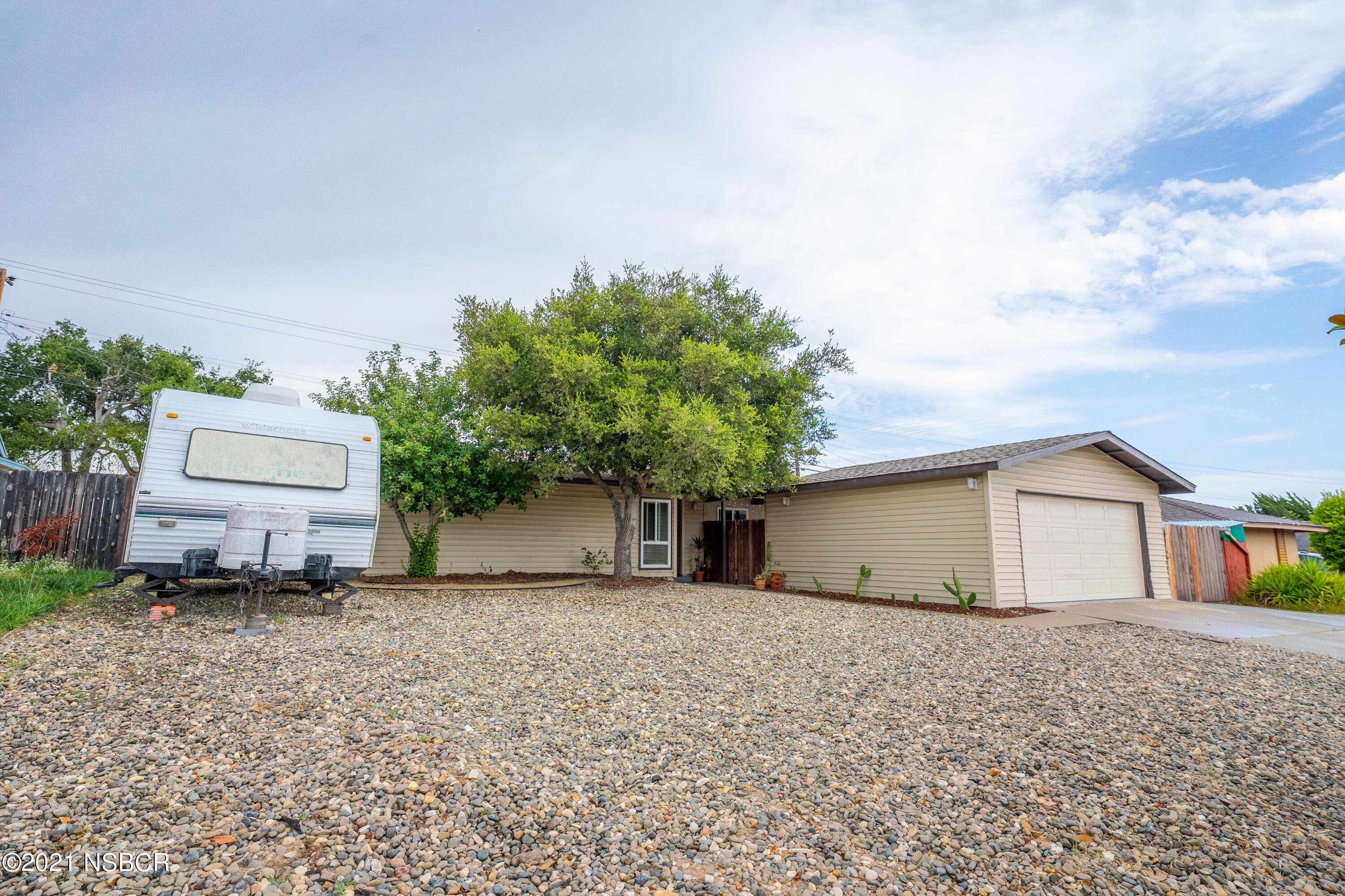 3985 Constellation Road Lompoc, CA 93436 - Photo 3 of 25 a front view of a house with a garden and yard