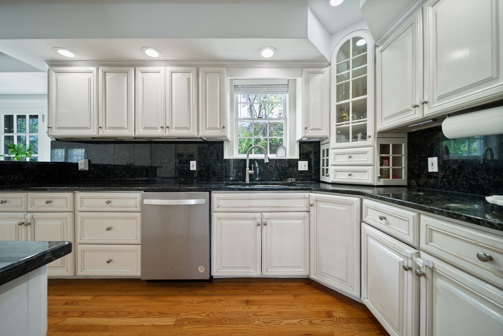87 Hammersmith Drive Saugus, MA 01906 - Photo 11 of 37 a kitchen with stainless steel appliances granite countertop a stove a sink and white cabinets