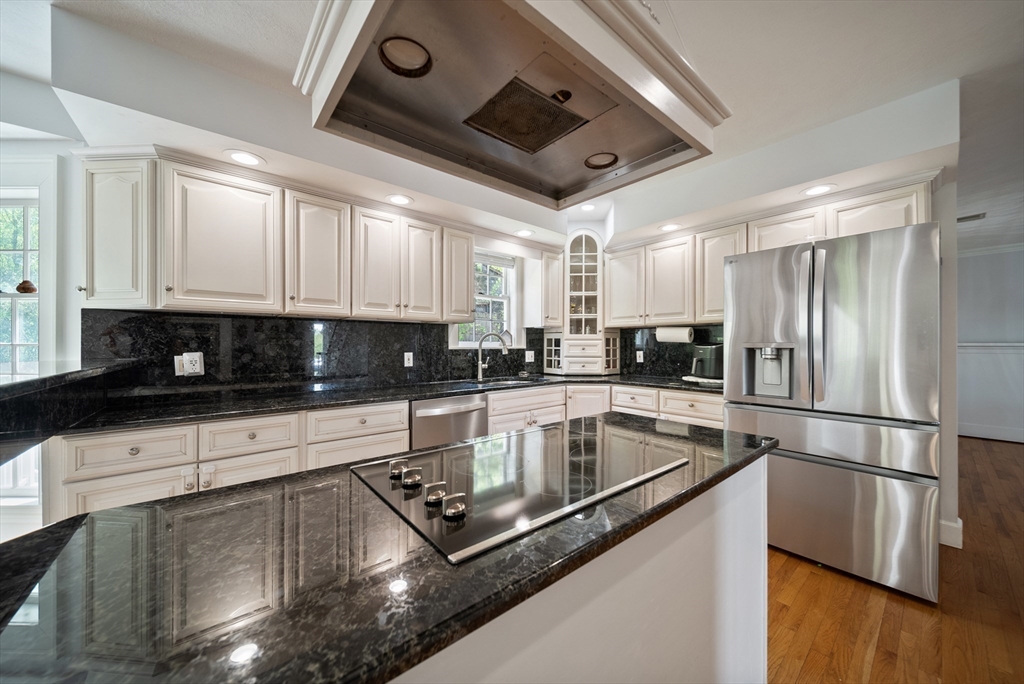 87 Hammersmith Drive Saugus, MA 01906 - Photo 13 of 37 a kitchen with stainless steel appliances granite countertop a refrigerator a sink a stove and white cabinets