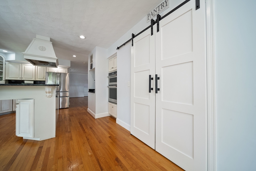 87 Hammersmith Drive Saugus, MA 01906 - Photo 15 of 37 a view of a kitchen with wooden floor
